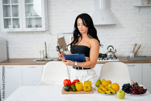 Young woman using digital tablet to plan her diet