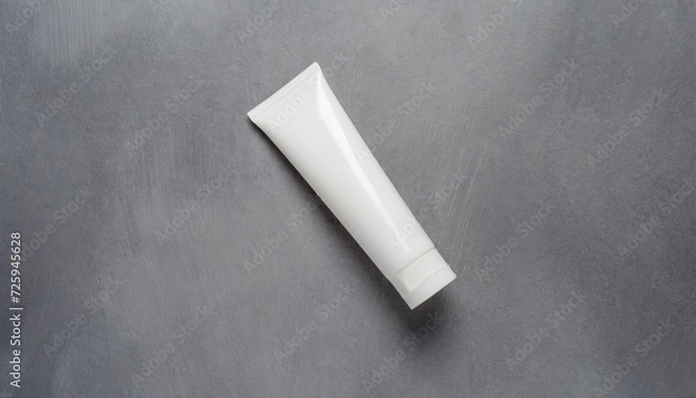 Mockup. White plain tube of cream on a gray background; view from above