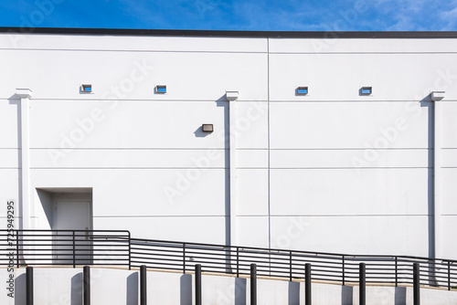 White Building Wall. Ramp and Railing