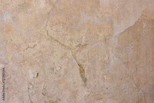 Old plastered wall with a crack. Concrete wall background.