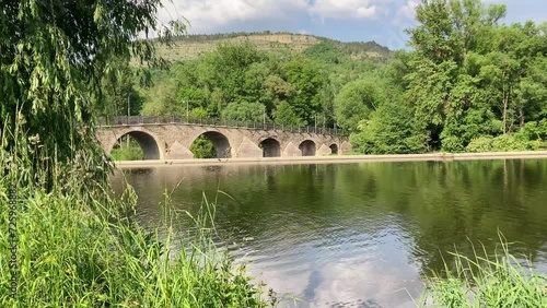 Saale river with historical bridge in Jena Burgau