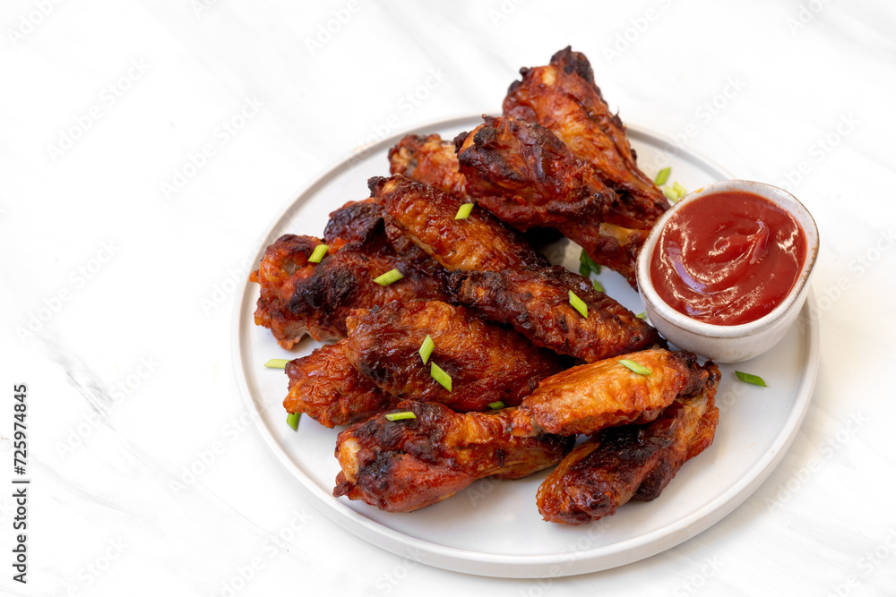 Spicy chicken wings in bbq sauce , spicy chicken wings cooked in the air fryer Spicy chicken wings in bbq sauce , spicy chicken wings cooked in the air fryer