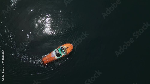 The yacht is standing on the water. The boat stands in the middle of the water. Aerial shot. Cannes. Italy. Wooden yacht. A man drives a yacht. People vacationing on a yacht in the sea. High quality