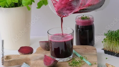 Beetroot smoothie is poured into a glass. Beetroot smoothie
