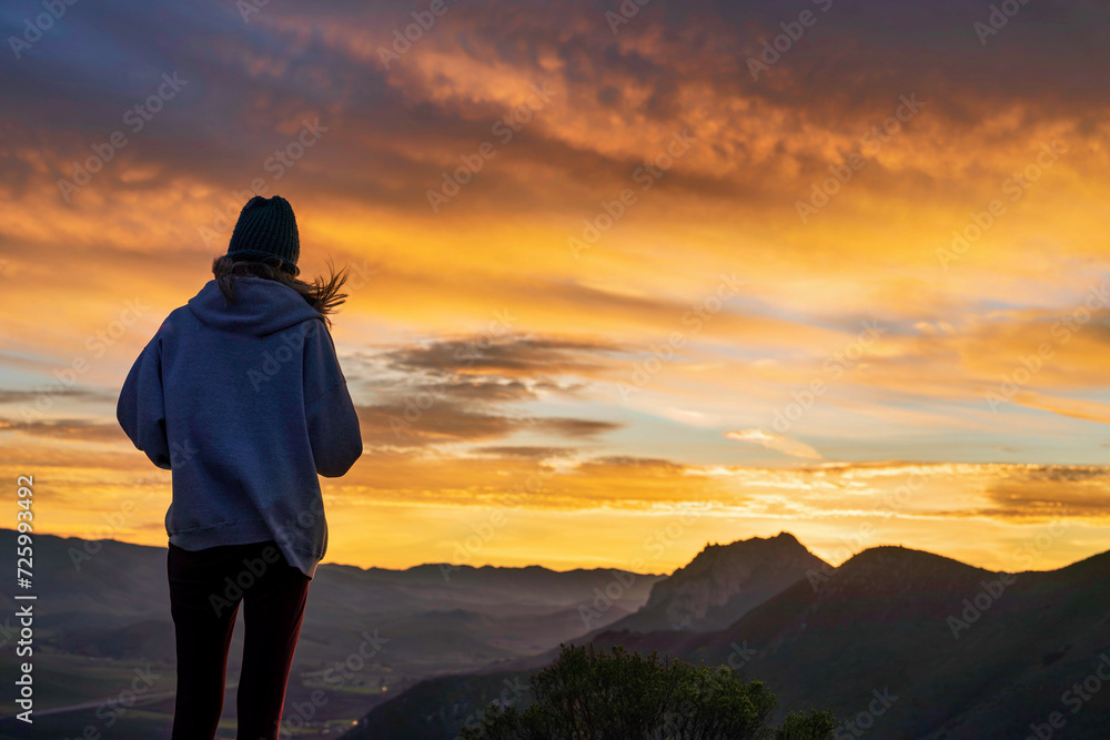 Silhouette of a girl at sunset, sunrise in the mountain