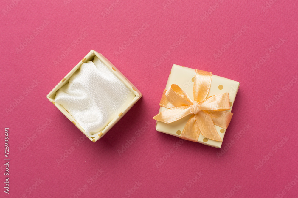 Beige open gift box on color background, top view Beige open gift box on color background, top view
