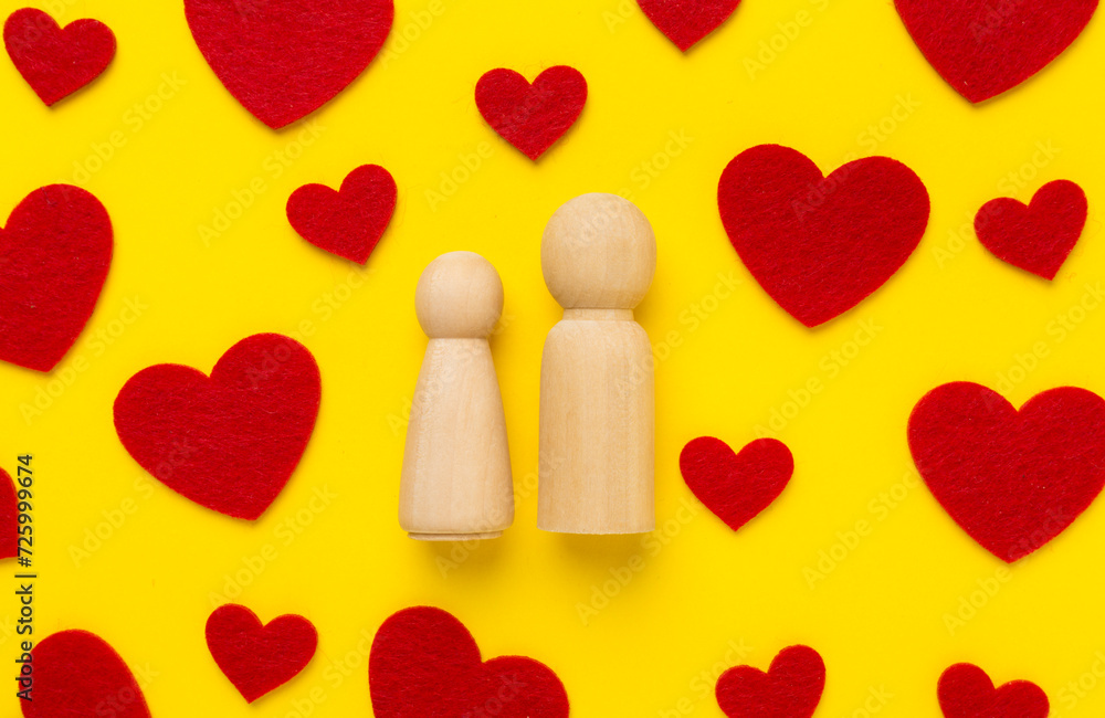Wooden couple in love on color background, top view. Creative valentine's day composition Wooden couple in love on color background, top view. Creative valentine's day composition