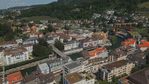 European city. A small town in swiss. Terracotta roof of houses. Forest. Summer. Residential area. River. Multistory houses. Green hills. Mountainous terrain. Switzerland. High quality 4k footage