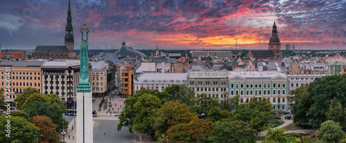 Beautiful sunrise view over Riga by the statue of liberty - Milda in Latvia. The monument of freedom.