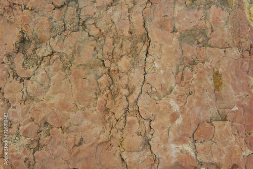 Brown stone texture close-up with shades of red.