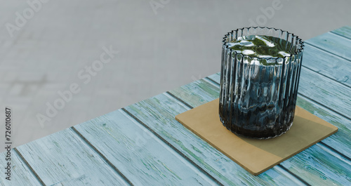 Wooden table with blue weathered paint, water served in glass cup on cup holder, drinks and relaxation