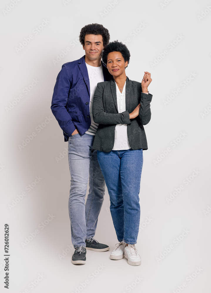 Portrait of confident young colleagues smiling and looking at camera over isolated white background Portrait of confident young colleagues smiling and looking at camera over isolated white background