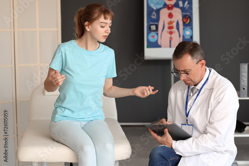 Mature doctor working with ...