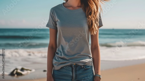 bohemian woman wearing a blank heather gray bella canvas 3001 tshirt mockup, backgound walking on the beach,   photo