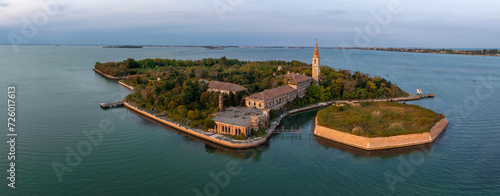 Aerial view of the plagued ghost island of Poveglia in the Venetian lagoon, opposite Malamocco along the Canal Orfano near Venice, Italy. photo