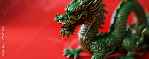 Green Chinese Dragon on red background. The year of the Dragon in China and Eastern Asia. One of the Chinese zodiac signs. New Year of the Dragon 2024. Card or banner with copy space © ratatosk
