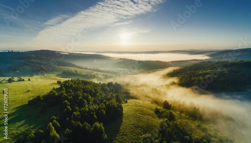beautiful valley with a green forest at sunrise