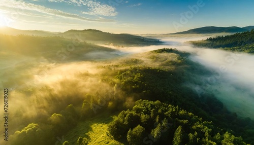 beautiful valley with a green forest at sunrise © RAYNAN