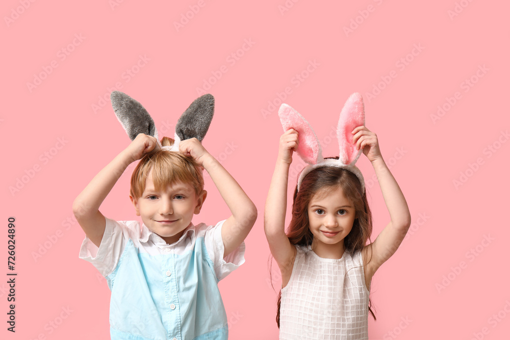 Cute little children in bunny ears on pink background Cute little children in bunny ears on pink background