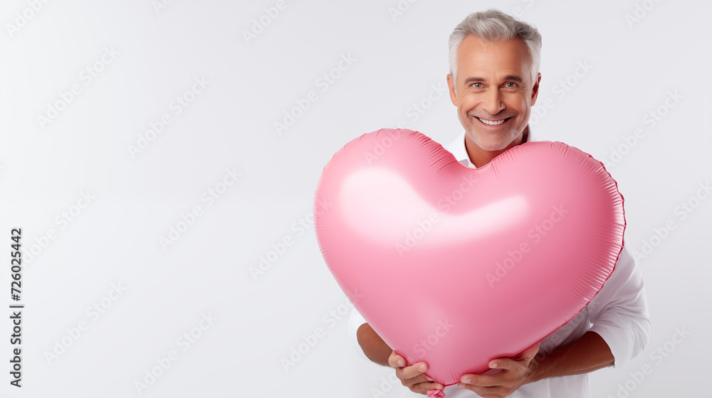 Valentine's Day Attractive Man Smiling and Holding A Big Pink Balloon Valentine's Day Attractive Man Smiling and Holding A Big Pink Balloon