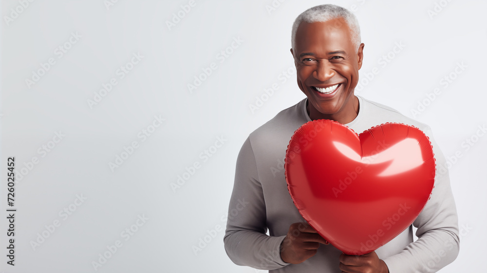 Valentine's Day Attractive Mature African American Man Smiling and Holding A Big Red Balloon Valentine's Day Attractive Mature African American Man Smiling and Holding A Big Red Balloon
