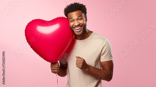 Valentine's Day Attractive African American Man Smiling and Holding A Big Red Balloon © Mircea Maties