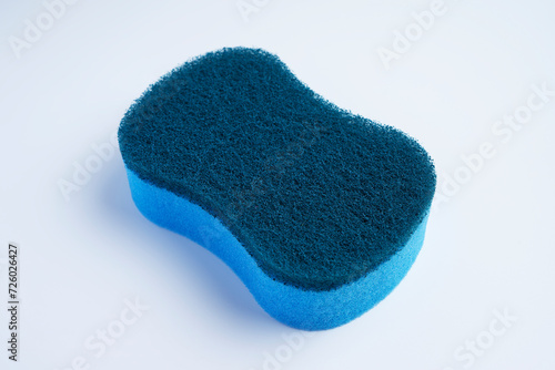 A blue dishwashing scrubber made with different materials on the top and bottom