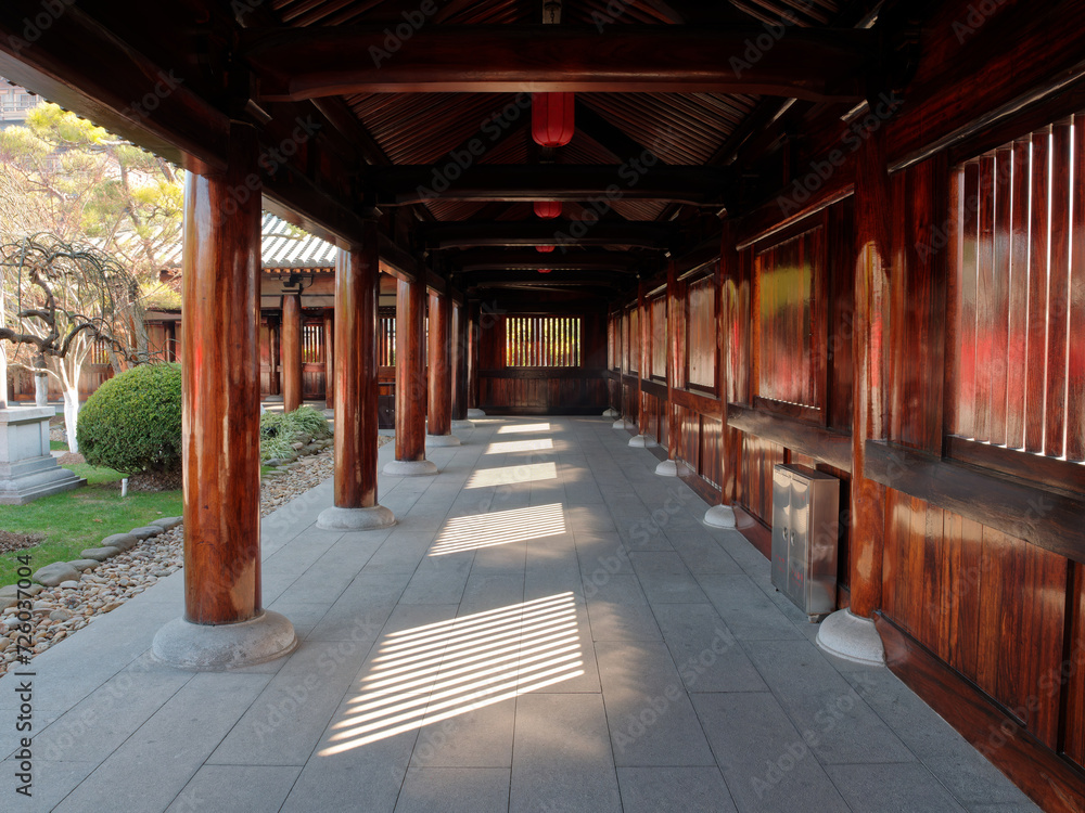 Beautiful wooden corridor of Baoshan Temple in Baoshan district, Shanghai, China. Bathed in summer sunlight.