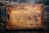 Above view of old cutting board on dark wooden table with copy space