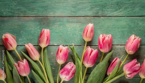 Tulip border with copy space. Beautiful frame of spring flowers. Bouquet of pink tulips flowers on green vintage wooden background  wallpaper  red tulips on wooden background