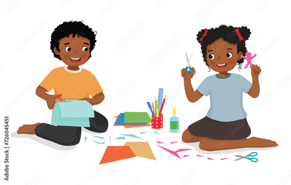 Cute little African kids cutting paper making art sitting on the floor together Cute little African kids cutting paper making art sitting on the floor together