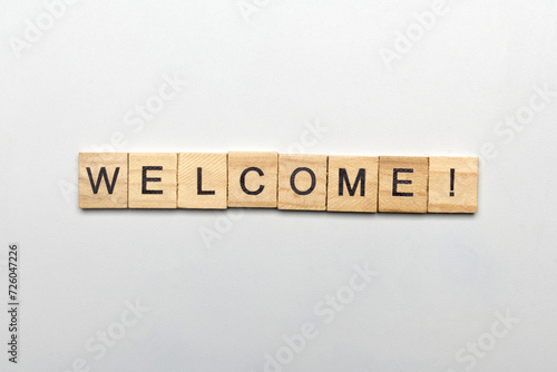 A row of wooden cubes with welcome text