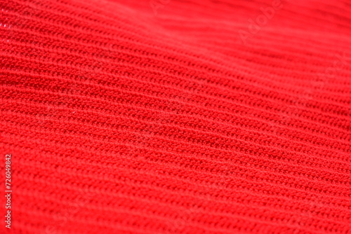 texture of red wool knitted yarn, woolen fabric background