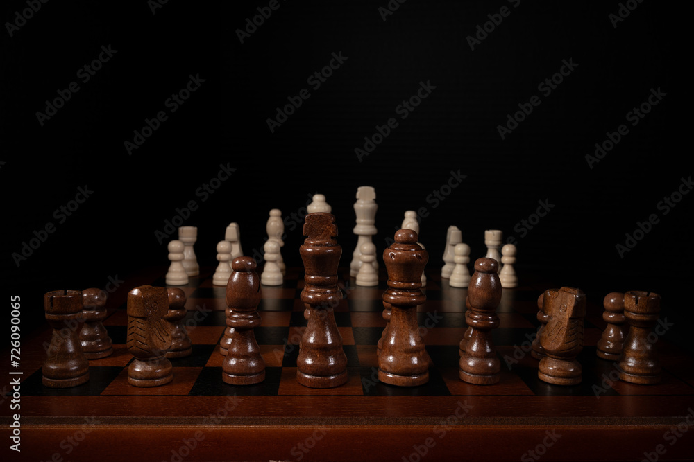 Close up of chess pieces on a chess board. King, queen, bishop, knight, and rook in the foreground. Close up of chess pieces on a chess board. King, queen, bishop, knight, and rook in the foreground.