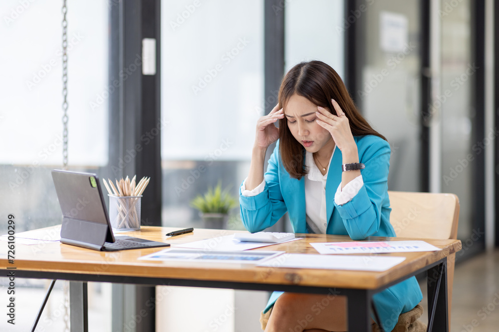 Shot of stressed, sleepy and bored business asian woman sitting at a desk on laptop for a long time and looking worried, tired and overwhelmed Shot of stressed, sleepy and bored business asian woman sitting at a desk on laptop for a long time and looking worried, tired and overwhelmed