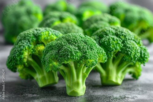 Vibrant green broccoli florets arranged on a dark surface, highlighting their texture and freshness photo
