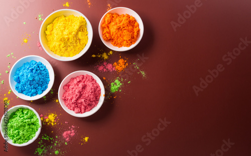 Happy Holi decoration, the indian festival.Top view of colorful holi powder on dark background.