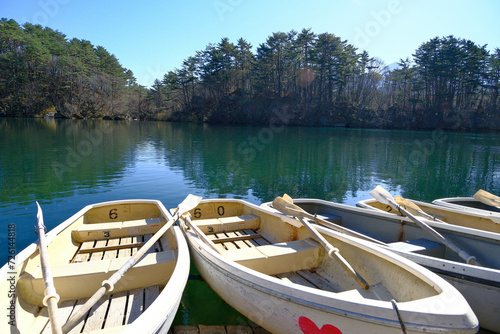 Landscape of view the Japan lake in Autumn season with wooden boat.