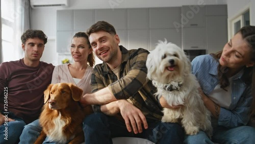 Friendly gathering pets owners at cozy living room. Happy friends sitting home  photo