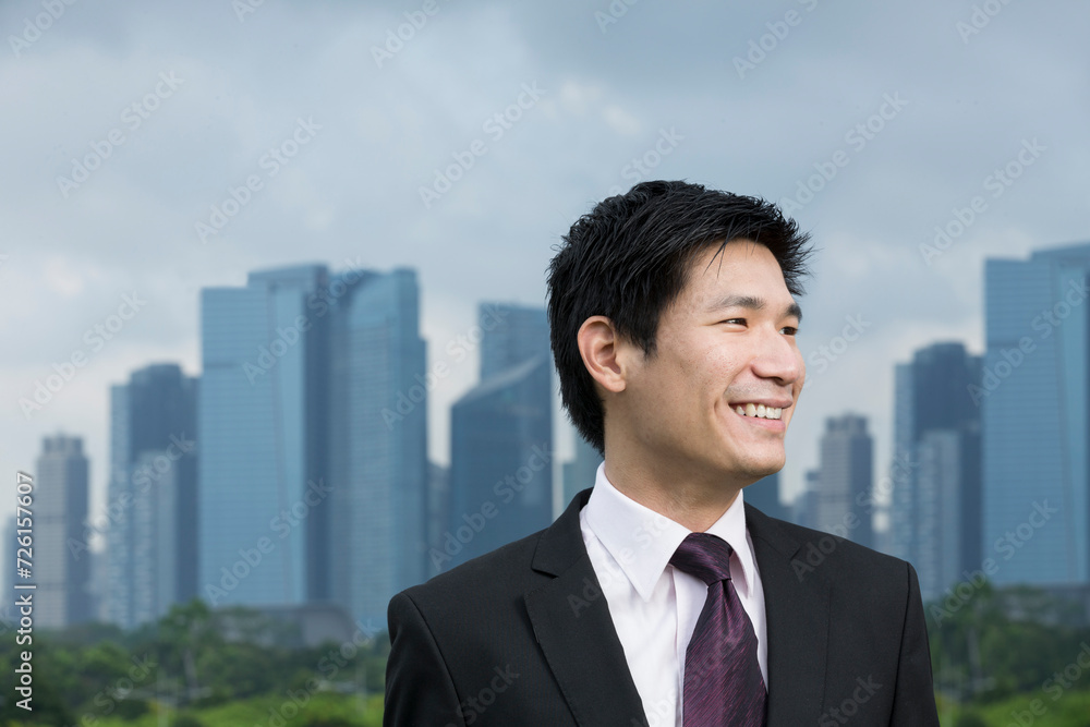 Happy asian business man in front of city. Happy asian business man in front of city.