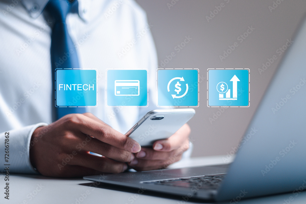 Fintech and digital money concept. Businessman use laptop with virtual fintech icons for digital banking, internet payment, online shopping, financial technology.