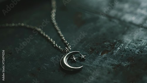 A delicate silver chain with a pendant of a shining moon and stars symbolizing the connection between angels and the divine. photo
