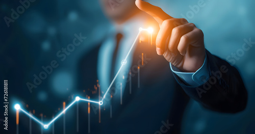 A businessman pointing to an arrow graph symbolizing corporate future growth plans. The concept of business development leading to success and continuous growth. photo