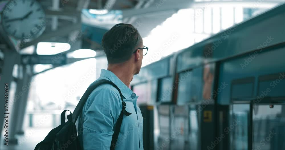 Businessman at station, late for important meeting and is in hurry. Man stands at metro station and looks at watch, checking time with arriving train. Concept rush to work and bustle at metro station. Businessman at station, late for important meeting and is in hurry. Man stands at metro station and looks at watch, checking time with arriving train. Concept rush to work and bustle at metro station.