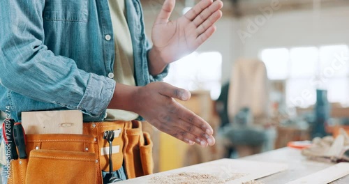 Man, hands and carpenter with dust, powder or finish for production, construction or crafting at workshop. Closeup of male person, builder or woodworker clapping dirt, sawdust or cutting on bench photo