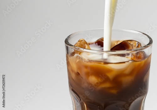 Milk poured over Iced Coffee