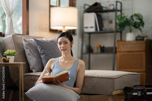 Asian woman doing activities, reading books, shopping online order through the internet at home or 