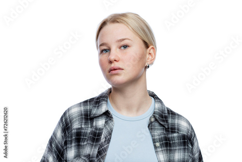 Teenage girl with a dissatisfied face. Cute blonde girl looking down. Depression and aggression. Isolated on a white background.