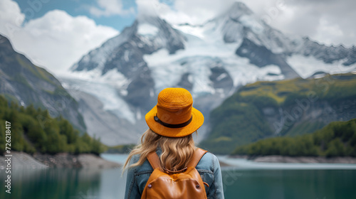 AI generated illustration of a female traveler with an orange hat admires the snow-capped peaks