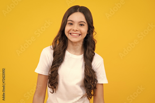 Little kid girl 12,13, 14 years old on isolated background. Children studio portrait. Emotional kids face. Happy teenager, positive and smiling emotions of teen girl.